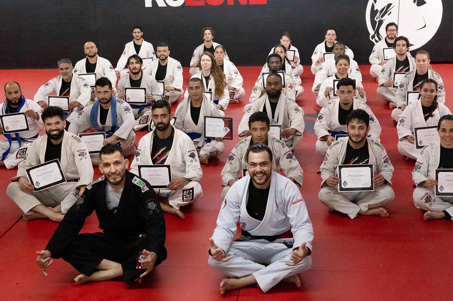 KO Zone Miami Brazilian Jiu-Jitsu graduation ceremony with students in gis holding certificates