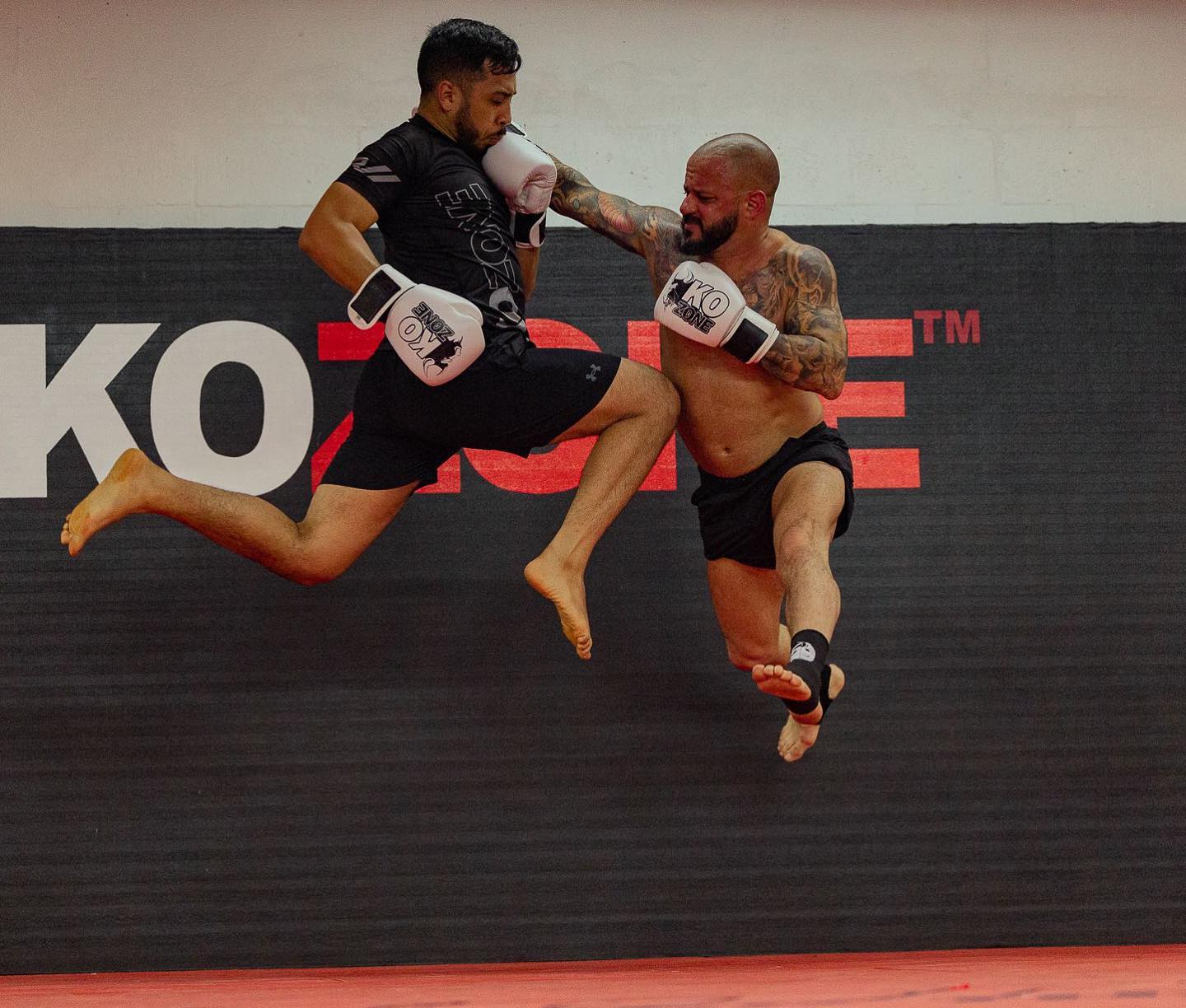 High-flying kick exchange showing taekwondo-style striking at KO Zone