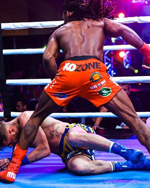 KO Zone professional boxer landing knockdown in the ring wearing KO Zone shorts